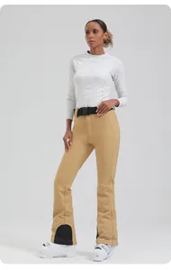 Detail view of khaki waterproof ski pants with adjustable buckle belt and snow boots