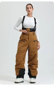 Detail of caramel bib ski pants with adjustable black waist and waterproof zip pockets