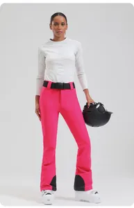Women's rose pink slim-fit ski pants featuring adjustable black belt and high waist detail