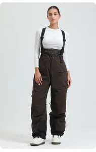 Detail of dark brown waterproof ski bib pants with adjustable straps and zipper pockets