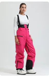 Detail of rose pink waterproof bib ski pants with adjustable black straps and side pockets