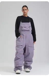Detailansicht der hellvioletten, locker sitzenden Skihose mit schwarzen Trägern und Taschen