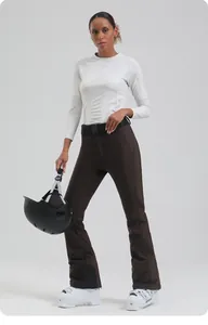 Women's slim fit ski pants in brown featuring a functional black belt for winter sports