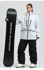 Detail of white hooded ski jacket with black zipper pockets and windproof velcro cuffs