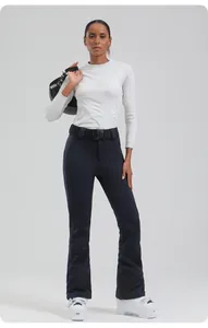 Slim fit women's ski pants paired with white thermal base layer and professional helmet