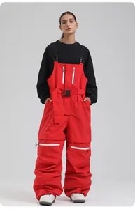 Detail einer roten Profi-Skilatzhose mit schwarzen Trägern und wasserdichten Taschen