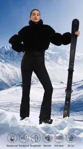 Close-up of waterproof black one-piece ski suit with fur collar on snowy mountain