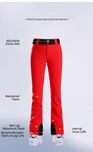Detail of red ski pants showing waterproof fabric and adjustable elastic waistband features