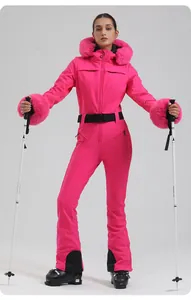 Close-up of rose pink slim-fit ski suit featuring plush faux fur trim and adjustable belt