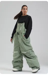 Detailansicht der hellgrünen wasserdichten Skilatzhose mit schwarzen Trägern und Taschen