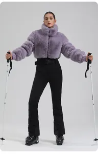 Detail view of purple faux fur ski jacket paired with slim black high-waisted ski pants