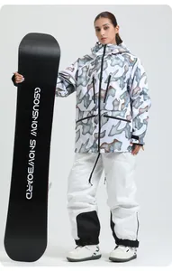 Close-up of women's camo ski jacket and white pants with durable black knee pads