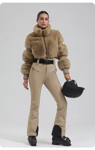 Detail of slim-fit khaki ski suit featuring faux fur jacket and high-waist pants