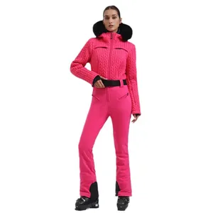 Women's pink quilted ski suit with faux fur hood and black belt for winter sports