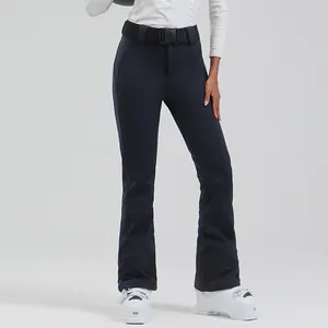 Women's slim fit waterproof high waist ski pants in dark blue with belt and flared hem