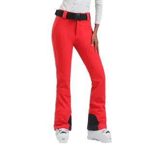 Women's slim fit red ski pants with black belt and waterproof insulated stretch fabric