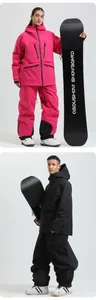 Detailed view of pink and black professional waterproof ski suits for men and women