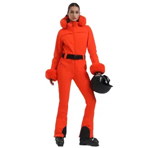Women's slim fit orange one-piece ski suit with fur hood and waterproof insulated fabric