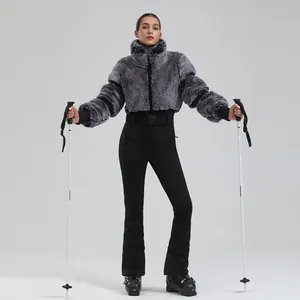 Women's slim-fit winter ski suit featuring grey fur jacket and black high-waist pants