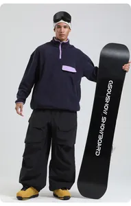 Deep purple fleece ski hoodie paired with black cargo snow pants and boots on a model