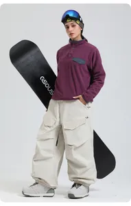 Outdoor winter ski set featuring purple fleece pullover and off-white cargo ski pants