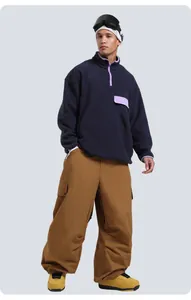 Full view of blue fleece jacket and brown cargo ski pants with outdoor boots