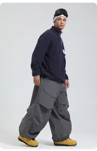 Winter outdoor sports outfit featuring dark blue fleece sweater and grey cargo ski pants