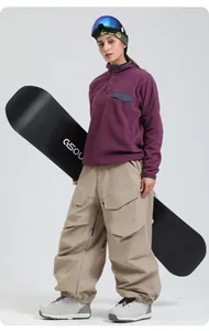 Detail of khaki cargo ski pants and purple fleece hoodie with functional pockets