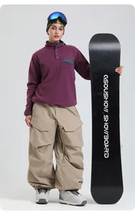 Detail of female model in purple fleece hoodie and oversized khaki cargo snowboard pants