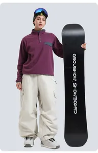Outdoor skiing outfit showing purple fleece top and off-white multi-pocket cargo ski pants