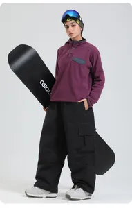 Détail du pantalon de ski noir coupe-vent avec coutures blanches et poches cargo