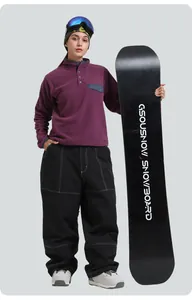 Detail of purple fleece pullover and black wide-leg ski pants with white stitching details