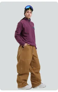 Winter outdoor snowboard pants with white contrast stitching and loose wide-leg design