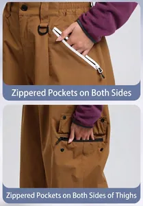 Detail view of side zipper pockets and thigh cargo pocket on khaki waterproof ski pants