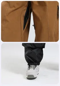Close-up of thigh ventilation zippers and snow skirts on waterproof ski pants