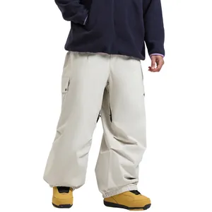 Loose beige waterproof ski pants with multi-pockets and drawstring hem for winter sports
