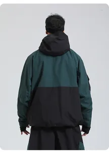 Detail view of the waterproof hooded ski jacket back with dark green and black color blocking