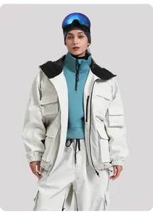 Detail view of white waterproof ski jacket with multiple cargo pockets and hooded design