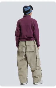 Back view of khaki corduroy cargo pants with purple fleece and GSOU SNOW beanie