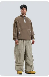 Detail of loose olive corduroy ski pants with large utility pockets for outdoor sports