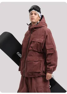 Detail view of burgundy corduroy ski jacket with multi-pocket utility design and hood