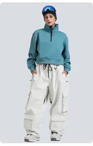 Detail of loose fit corduroy ski pants with multi-pockets and waterproof finish