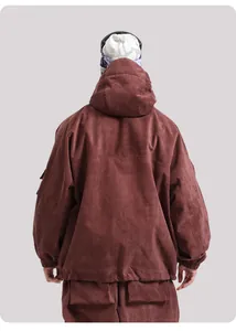 Detail of waterproof corduroy ski jacket with hood and back panel stitching in brick red