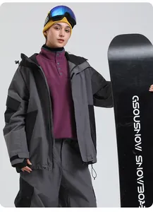 Women's grey and black waterproof ski jacket and pants set with a purple fleece layer