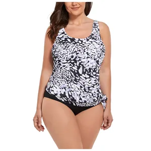 Detail of plus size tankini set with purple floral print top and black bikini bottom