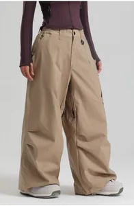 Detail view of khaki waterproof ski pants with adjustable waist and cargo pockets