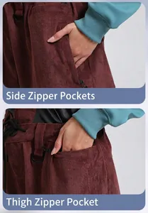 Detail view of corduroy ski pants featuring functional zipper pockets and D-ring attachment