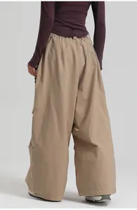 Detail of khaki wide-leg ski pants with cargo pockets and elastic waistband