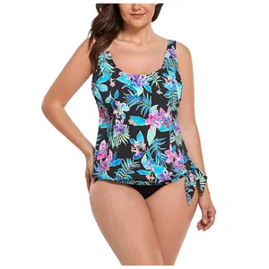 Detail of tropical floral tankini top with side drawstring ties and black bottoms