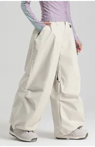 Close-up of off-white waterproof ski pants showing loose fit and functional pocket details